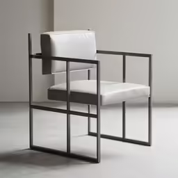 a white chair with black metal frame, in a concrete room