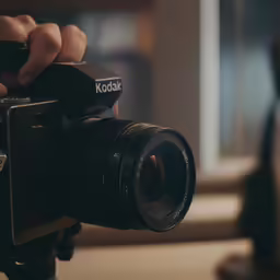 a camera being held with a camera attached to it