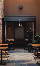 patio seating set out from the outside with a clock on the wall