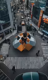 a person sitting on top of a large umbrella