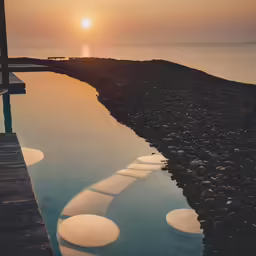 a dock and pathway in front of the ocean