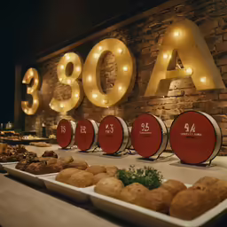 several beer barrels are set up next to plates full of baked goods