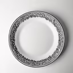 black and white dinner plates against a grey wall