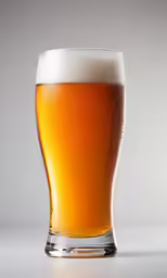 the glass is full with beer next to it