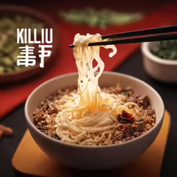 someone is eating a bowl of noodles in chinese