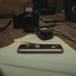 a cell phone and some electronics on a table