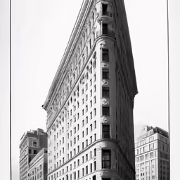 an upward view of the corner of a tall building in new york city