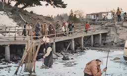 a group of people on the bridge next to snow