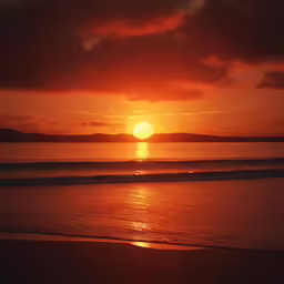a sunset over water with a very bright red cloud