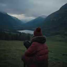 a woman wearing a red parka and a hat