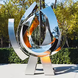 large metal sculpture with an orange and yellow circle