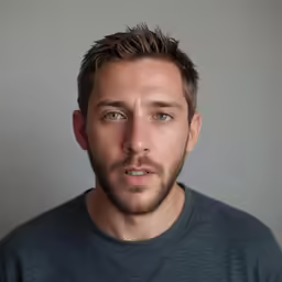 the young man is looking into the camera
