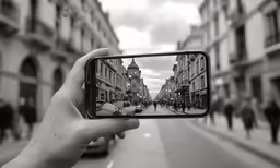 someone takes a photo of their cell phone outside