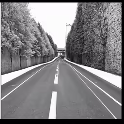 a black and white photo of a road