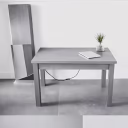 an artistic desk and chair sit in two different angles