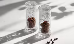 two clear vases that have some coffee beans inside