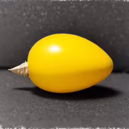 a yellow object sits on a dark table