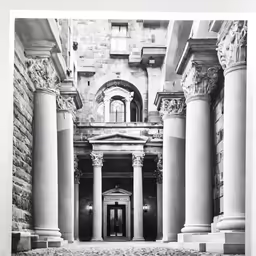 columns inside the building, which is lined with marble tiles