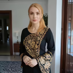 a woman posing in front of the camera with her hands on her hips