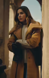 a woman standing next to a wall