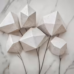 three white concrete ornaments placed on top of each other