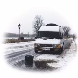 an old van is driving on a snowy road