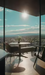 a deck with a table and chairs overlooking a city