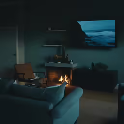 the interior of a living room with a fire place and blue couches