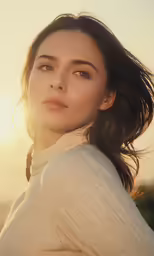 a beautiful woman in white clothes standing near the beach