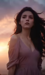a woman with long, flowing hair in front of a sunset