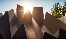the sun is shining through some mountains made of paper
