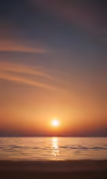 the sun setting over the ocean and beach with two surfboards