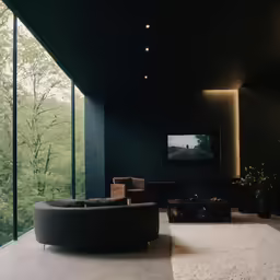 a room with large windows and an armless couch