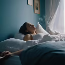 a woman laying on her bed with bubbles coming from her face