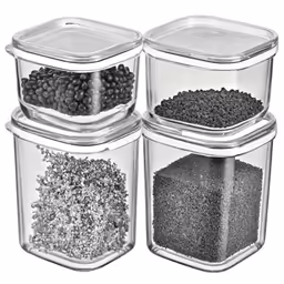 three clear glass containers are stacked high