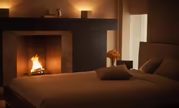 bedroom with a fireplace and bed in the room