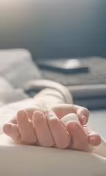 two hands resting on top of a couch
