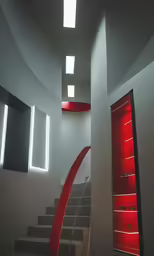 an empty room with stairs, windows and lighting