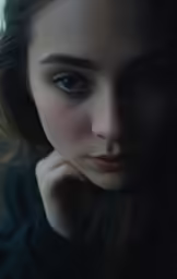 a young woman with brown eyes looking at the camera