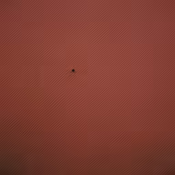 an open window with a brown frame on top of it