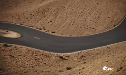 a view of an empty road and a winding drive
