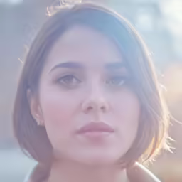 a woman with short brown hair is standing outside