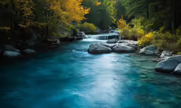 water flowing from rocks into a river