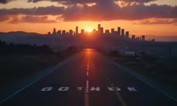 a very long road with the sun setting behind it