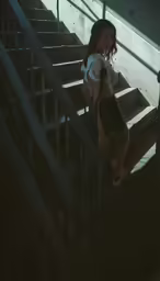 a woman walks down a flight of stairs