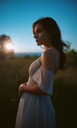 a woman is standing with her arms crossed near the sun