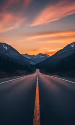 the light is on for the sun down as the long road crosses over the mountain
