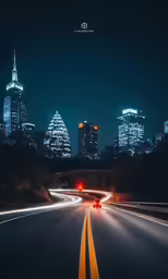 cars drive along a city highway near tall buildings
