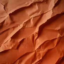 some orange colored dirt and the bottom of the paper