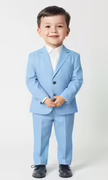 the young boy is dressed in a blue suit and tie